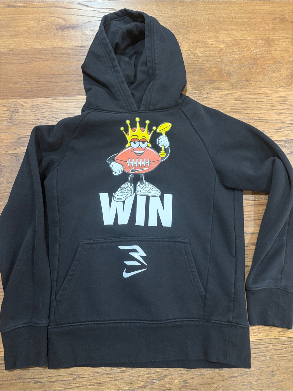 Nike Black Kids Hoodie with 'WIN' Football Character and Crown Graphic